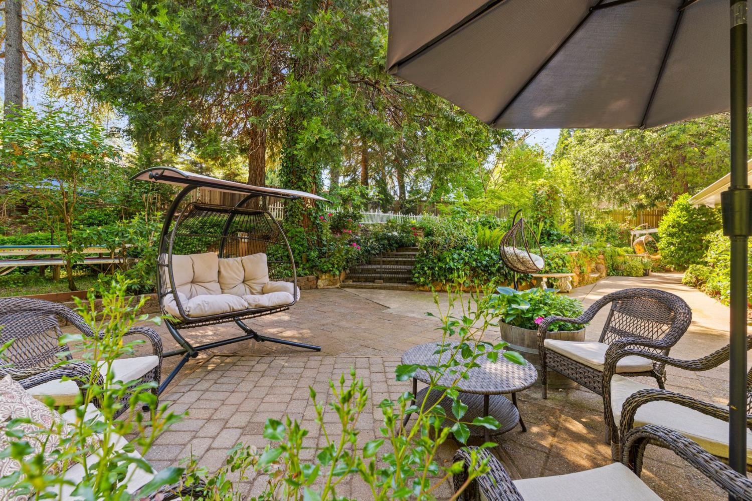 2812 Crystal Springs Road Camino, CA 95709 - Photo 25 of 28 a view of a chair and table in backyard with potted plants