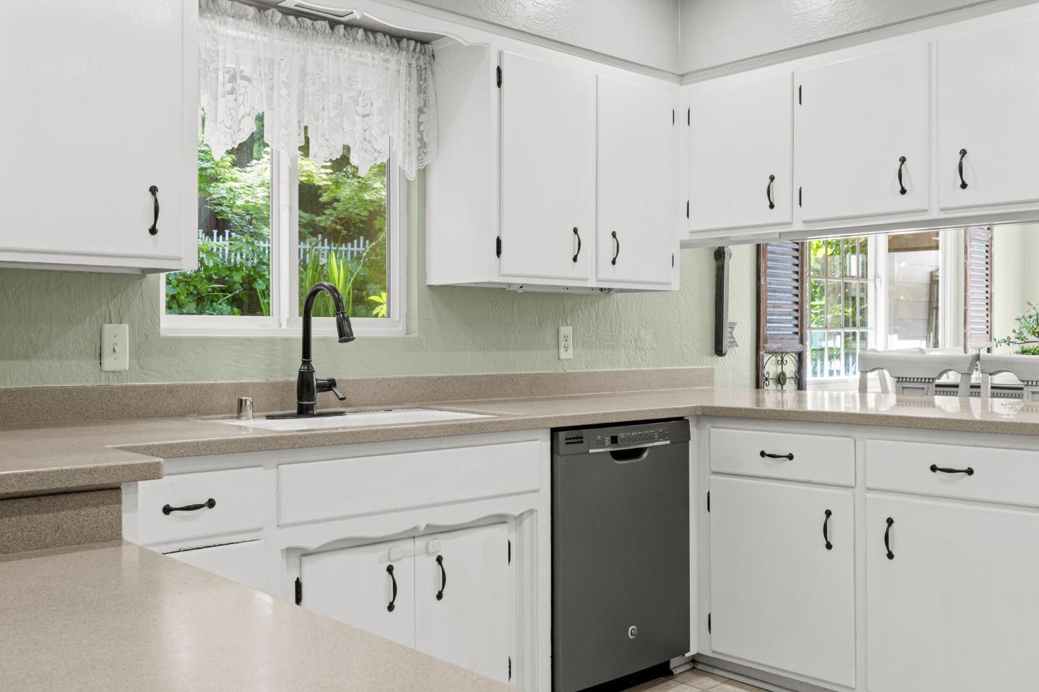 2812 Crystal Springs Road Camino, CA 95709 - Photo 7 of 28 a kitchen with granite countertop white cabinets white appliances and a sink