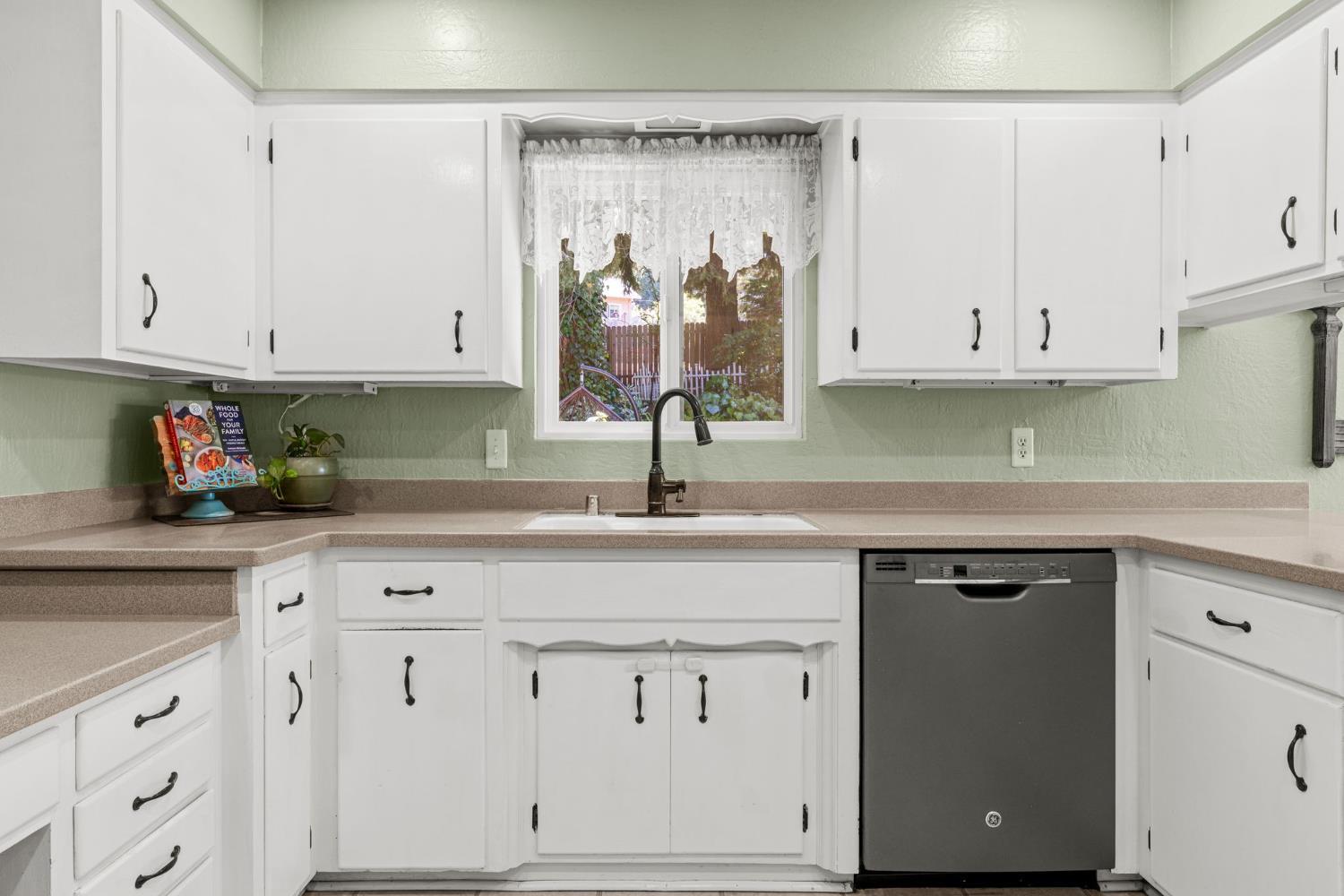 2812 Crystal Springs Road Camino, CA 95709 - Photo 8 of 28 a kitchen with white cabinets and white appliances