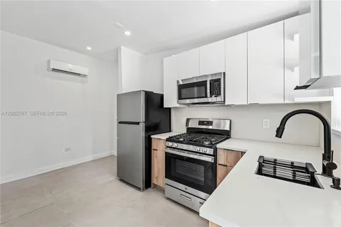 a kitchen with a refrigerator stove and microwave