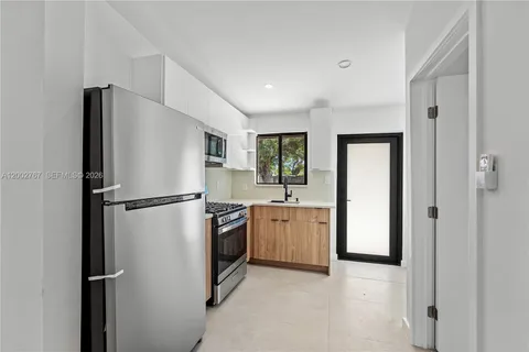 a kitchen with stainless steel appliances a refrigerator stove and sink