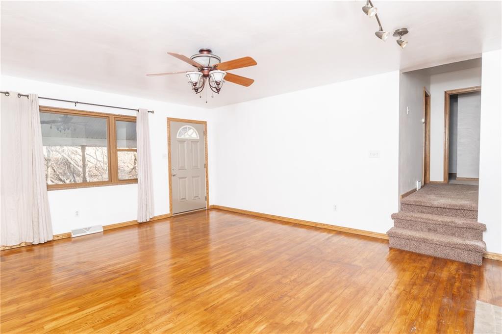 475 Crawford Run Road Creighton, PA 15030 - Photo 19 of 28 a view of a livingroom with wooden floor and a ceiling fan