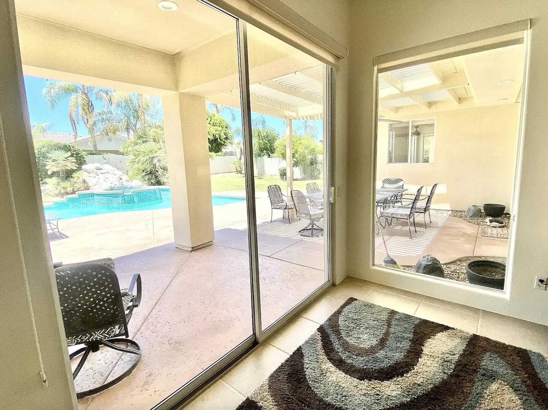 5 Victoria Falls Drive Rancho Mirage, CA 92270 - Photo 24 of 26 a living room with furniture and a floor to ceiling window