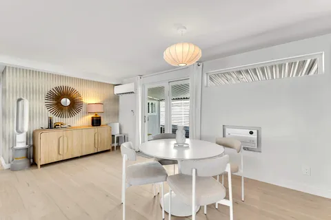 a bedroom with a bed and a lamp on dresser