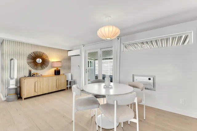 a bedroom with a bed and a lamp on dresser