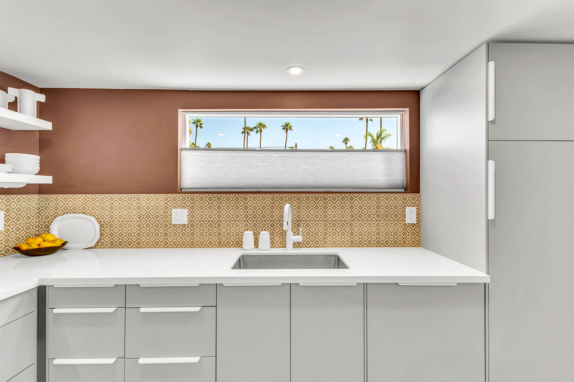 69 Nile Street Palm Springs, CA 92264 - Photo 46 of 68 a kitchen with a sink and a potted plant