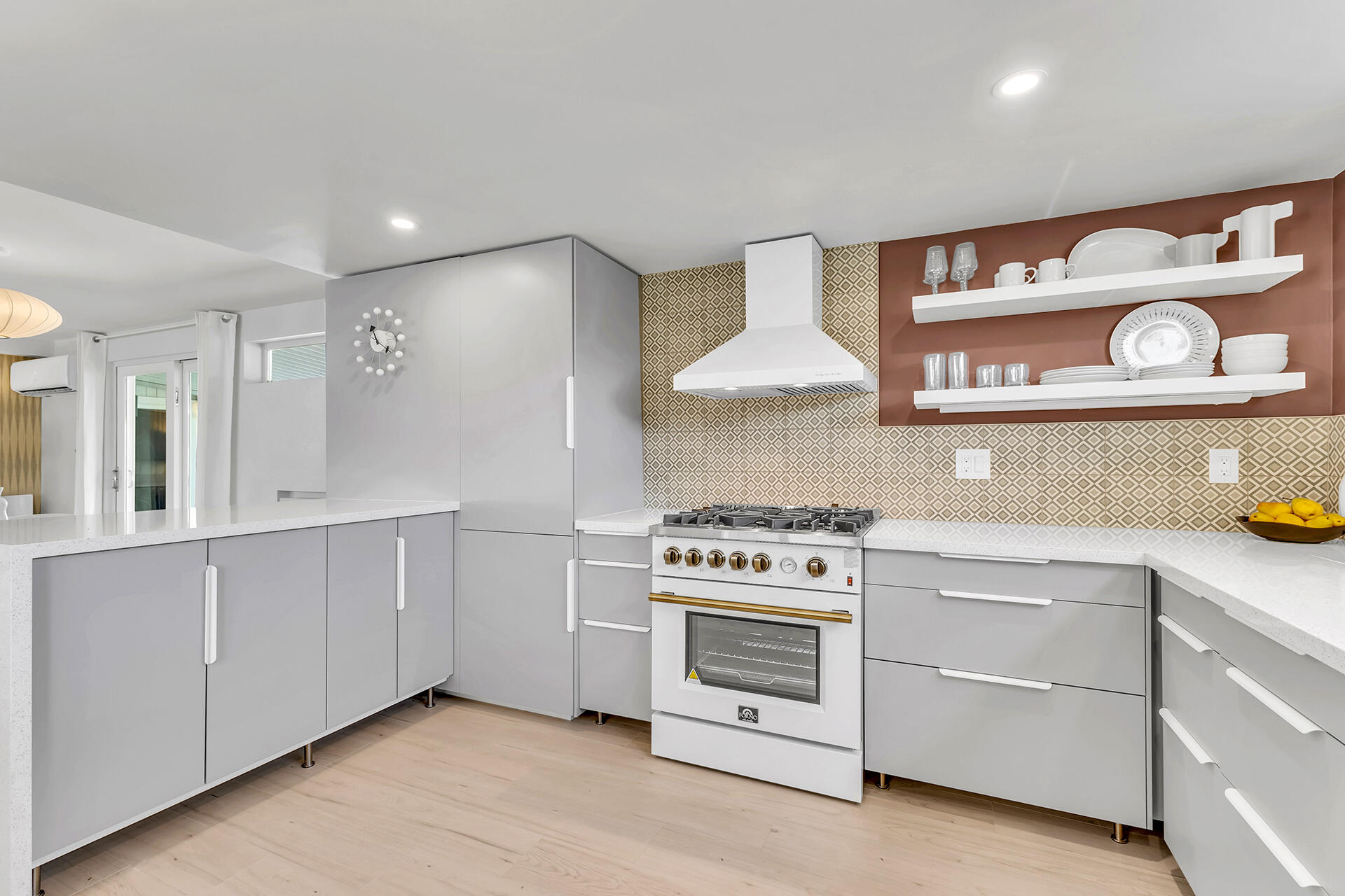 69 Nile Street Palm Springs, CA 92264 - Photo 6 of 68 a kitchen with white cabinets and a stove top oven