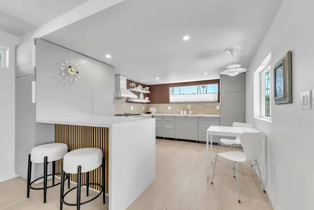 a bathroom with a shower and a glass door