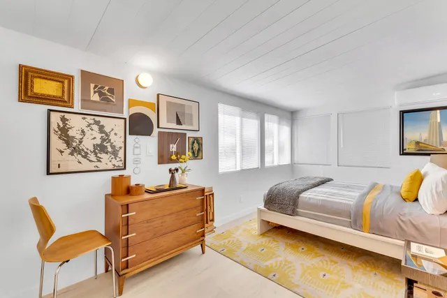 a close view of a kitchen with cabinets and washer dryer
