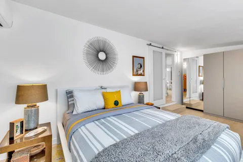 a view of staircase with wooden floor and a rug
