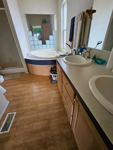 a bathroom with double vanity sink and a mirror