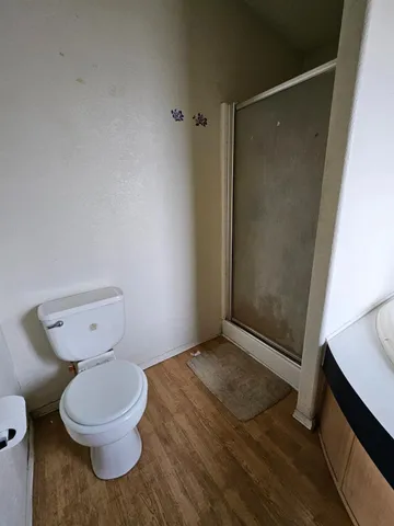a bathroom with a toilet and a shower