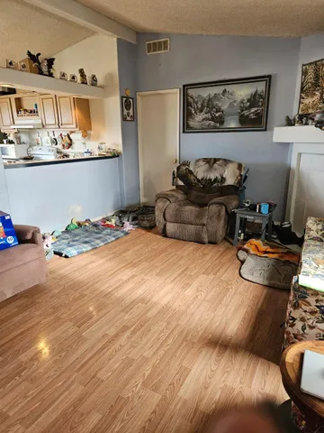 a living room with furniture and painting on the wall