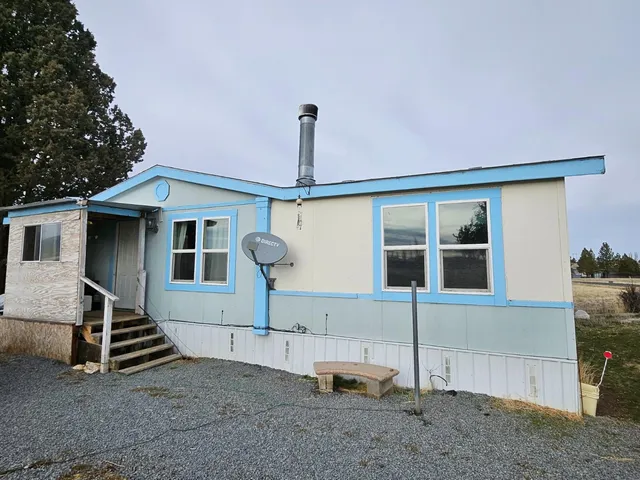 a front view of a house with parking space