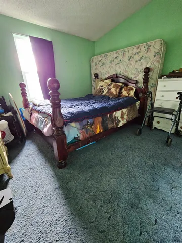 a bedroom with a bed and a chair