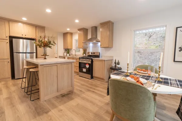 a kitchen with stainless steel appliances granite countertop a sink stove and refrigerator