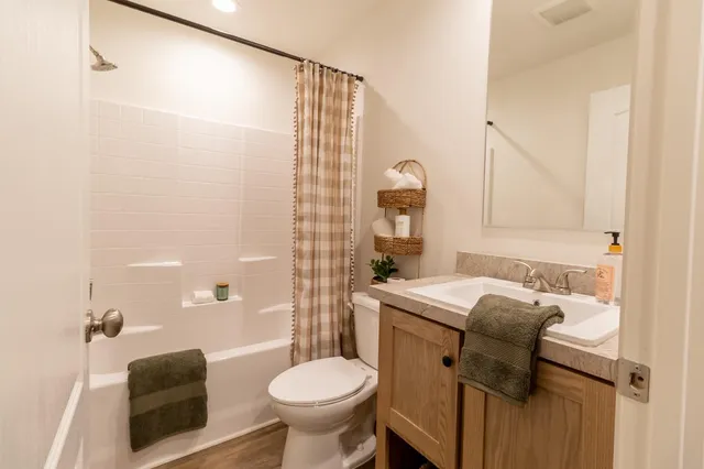 a bathroom with a sink toilet and shower