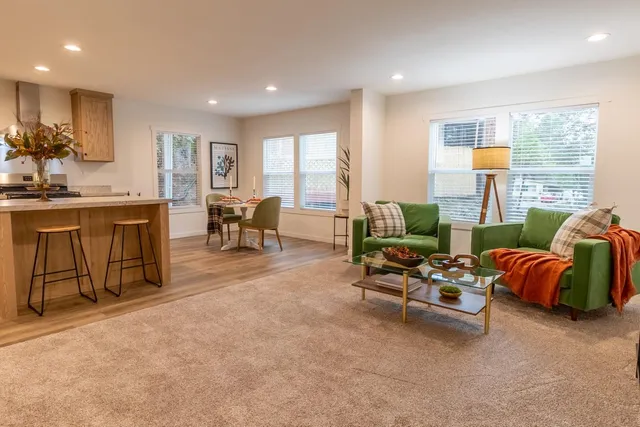 a living room with furniture and large windows