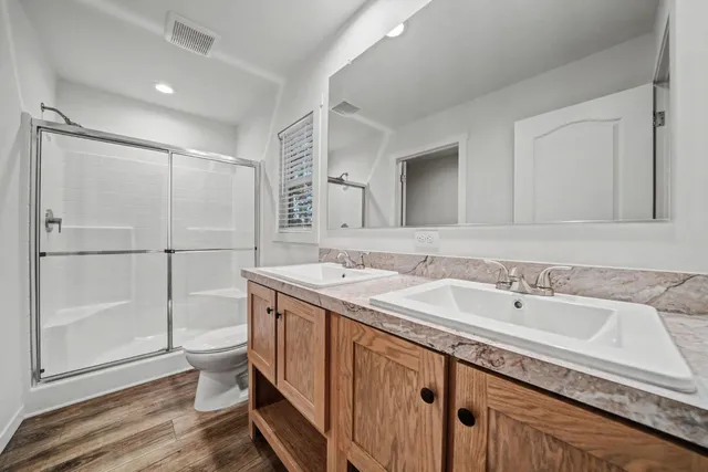 a spacious bathroom with a granite countertop sink mirror and double