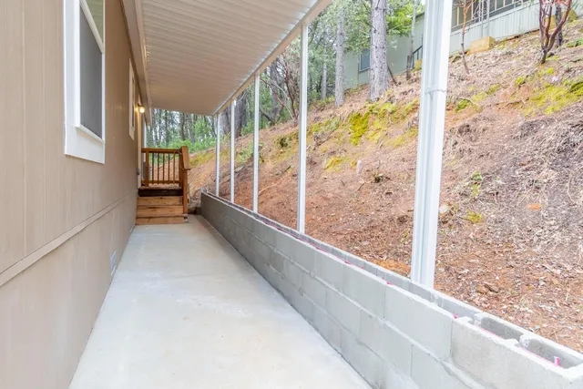 a view of a house with backyard and sitting area