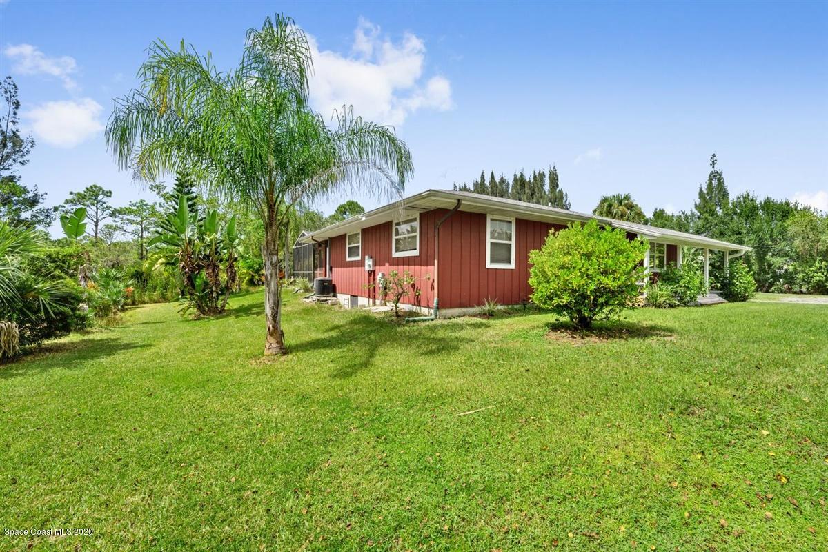 3600 Leghorn Road Grant Valkaria, FL 32950 - Photo 28 of 33 a front view of a house with garden