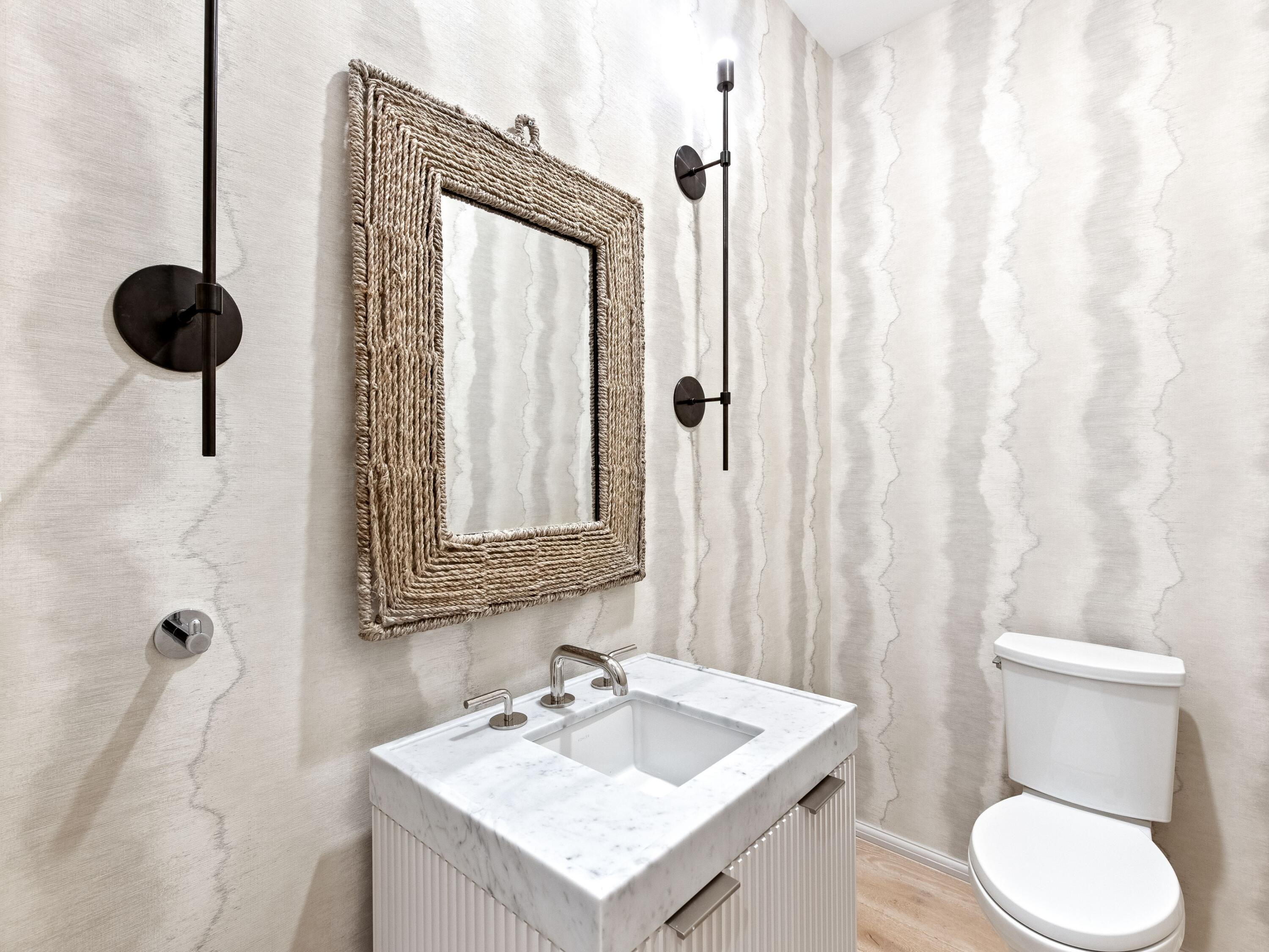 45 West Solaire Way Inlet Beach, Unit 103 Inlet Beach, FL 32461 - Photo 19 of 25 a bathroom with a toilet sink and mirror