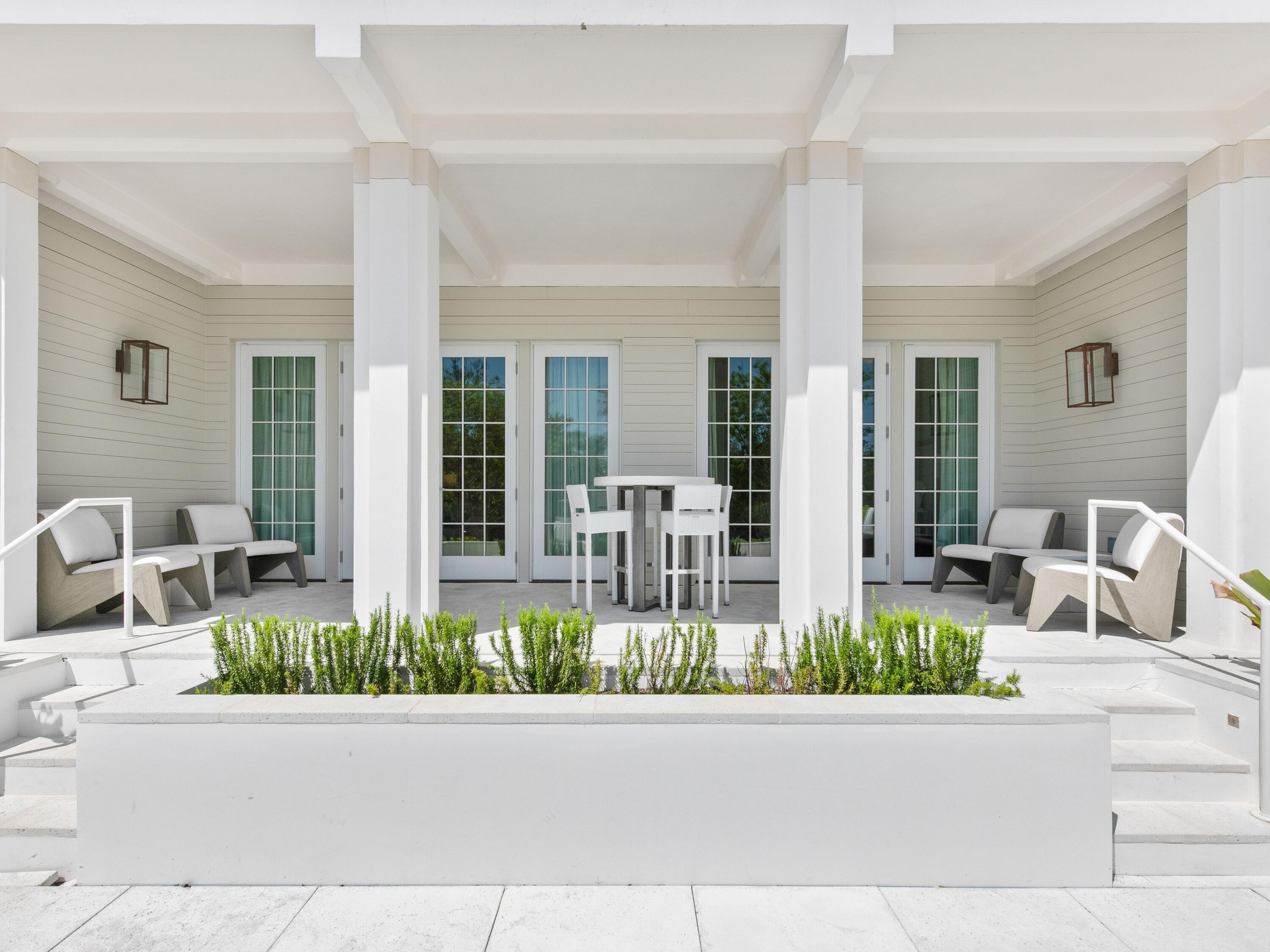 45 West Solaire Way Inlet Beach, Unit 103 Inlet Beach, FL 32461 - Photo 2 of 25 a front view of a house with porch and furniture