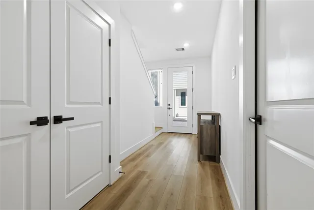 a view of a room with wooden floor
