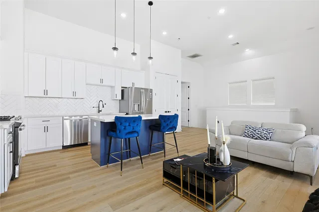 a living room with furniture and a wooden floor