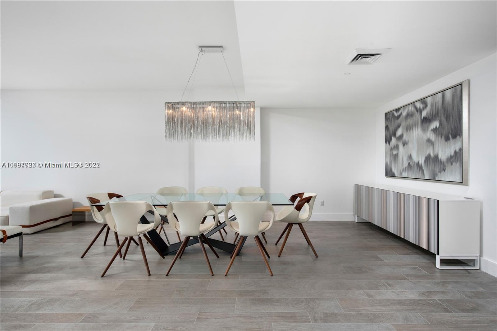 360 Ocean Drive, Unit 603S Key Biscayne, FL 33149 - Photo 18 of 29 a view of a dining room with furniture and wooden floor