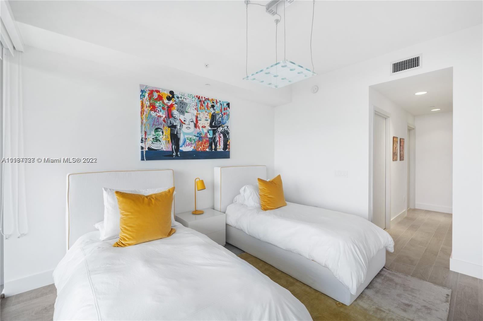 360 Ocean Drive, Unit 603S Key Biscayne, FL 33149 - Photo 21 of 29 a bedroom with a bed and a painting on the wall