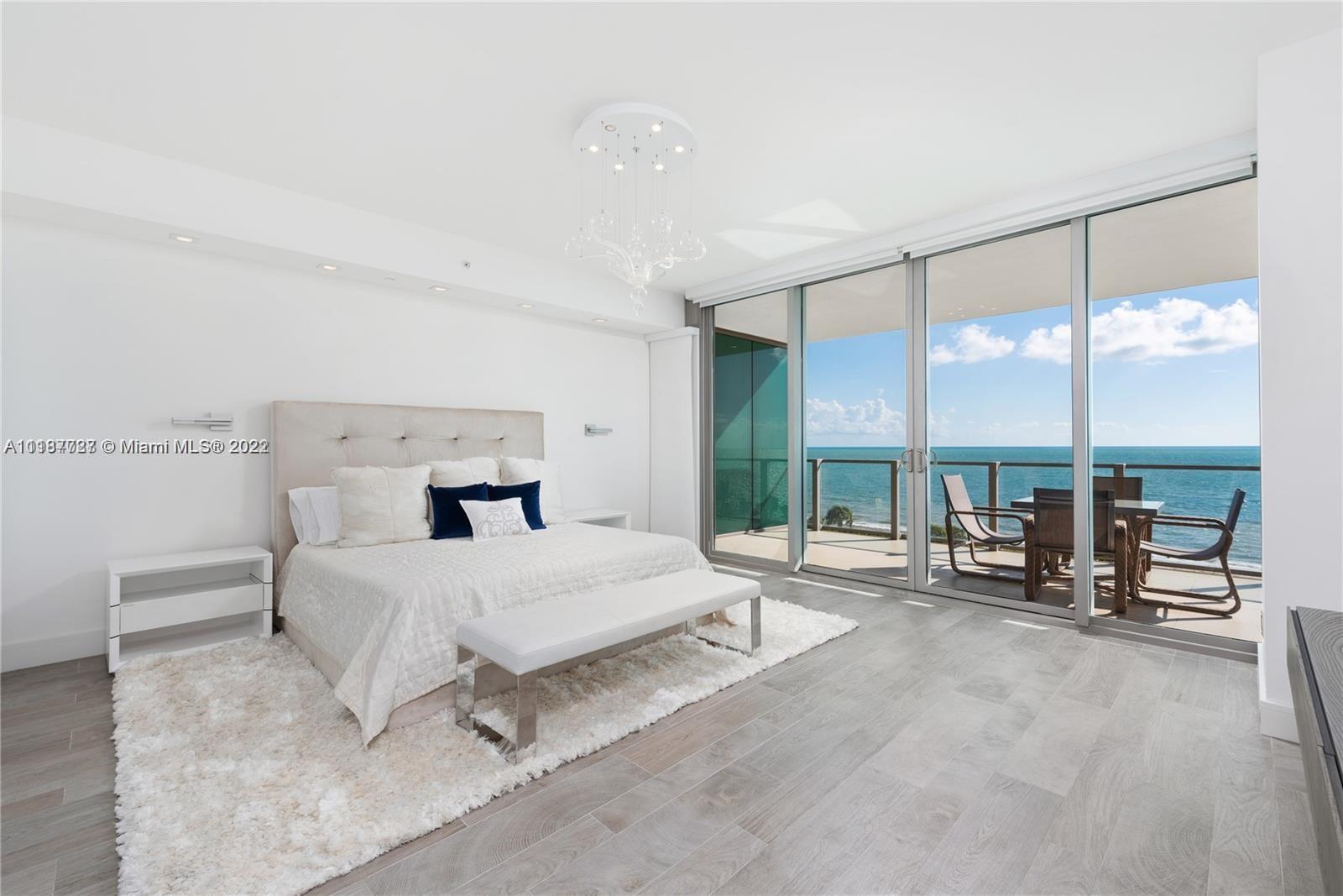 360 Ocean Drive, Unit 603S Key Biscayne, FL 33149 - Photo 27 of 29 a bedroom with a bed and large windows