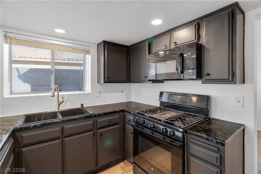 3156 Terrace View Drive Laughlin, NV 89029 - Photo 15 of 94 A well-appointed kitchen showcasing dark cabinetry, ample counter space, and modern appliances.