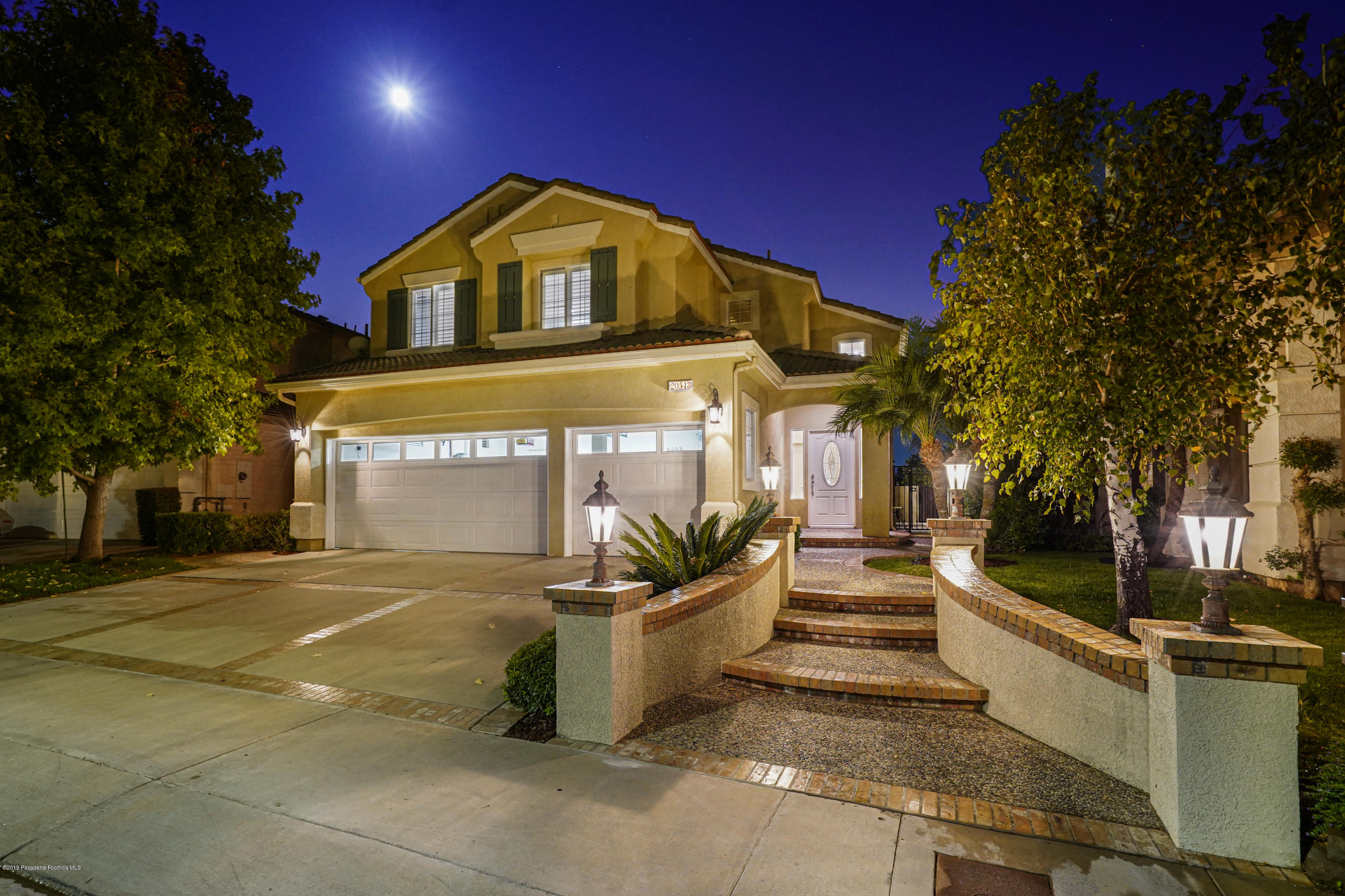 20548 Bergamo Way Porter Ranch, CA 91326 - Photo 3 of 58 a front view of a house with a yard