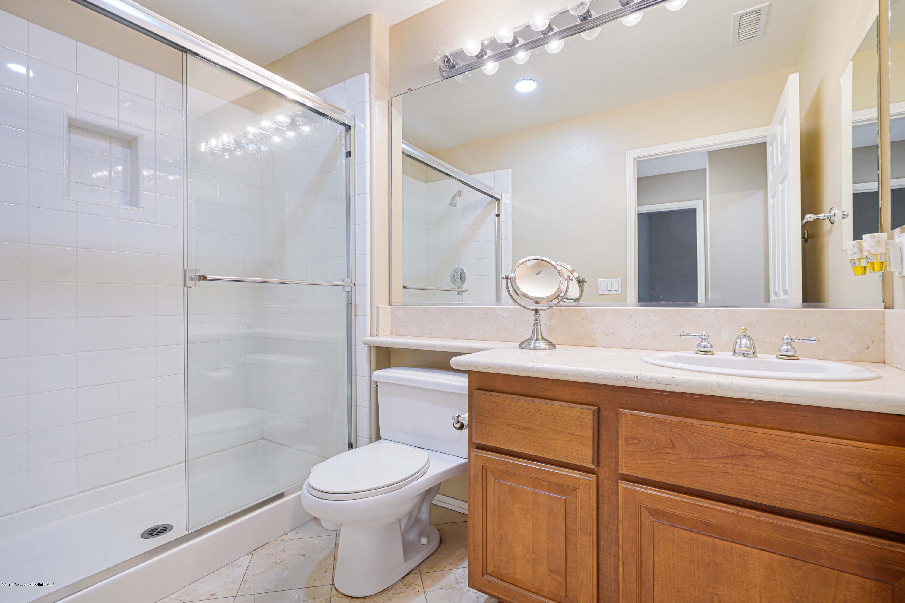 20548 Bergamo Way Porter Ranch, CA 91326 - Photo 22 of 58 a bathroom with a toilet a sink and a mirror