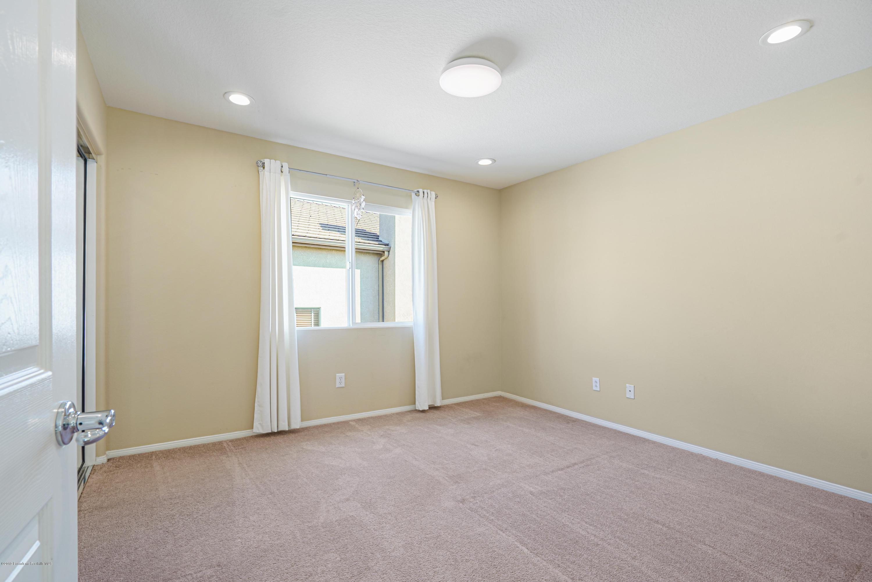 20548 Bergamo Way Porter Ranch, CA 91326 - Photo 27 of 58 an empty room with a empty space and windows
