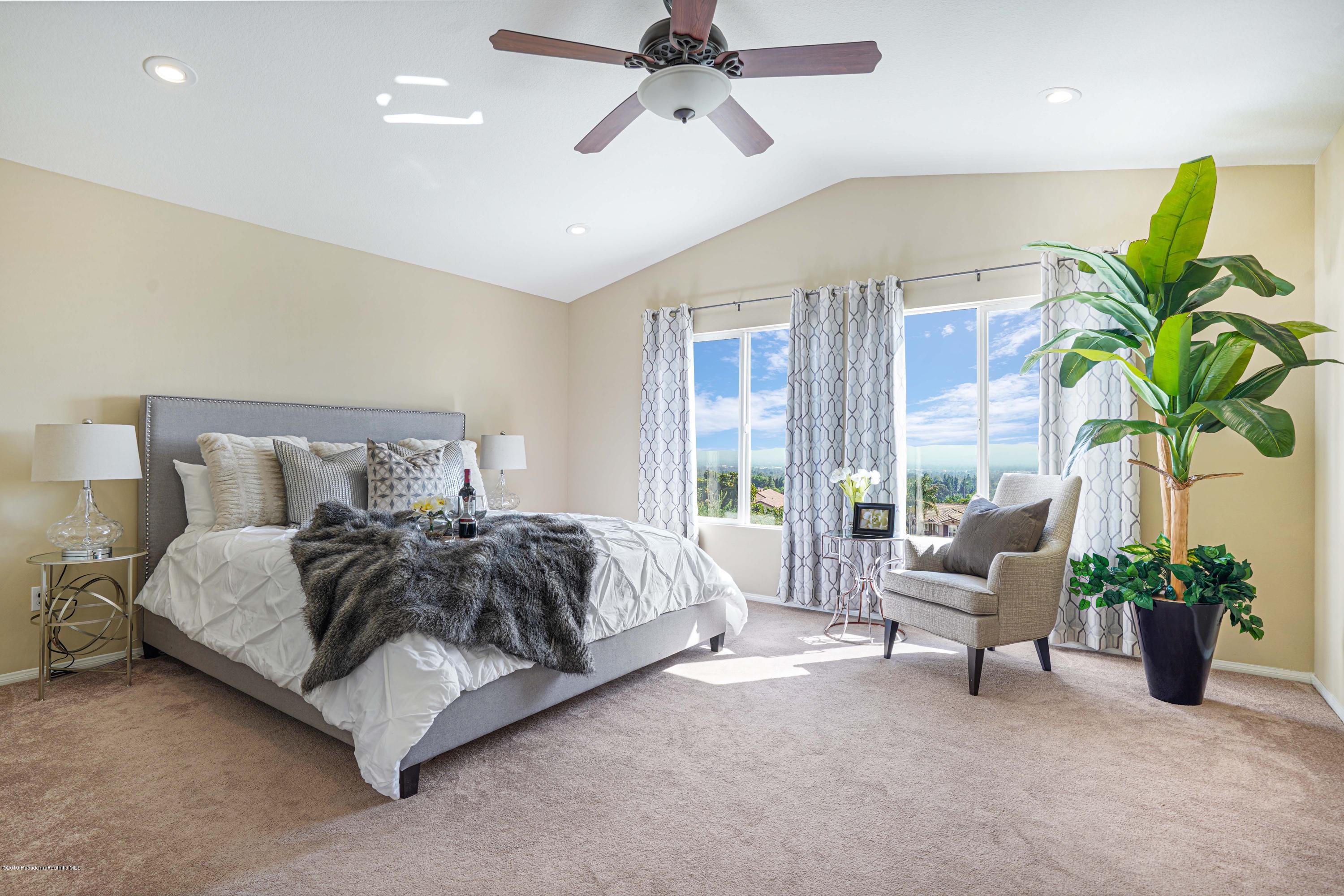 20548 Bergamo Way Porter Ranch, CA 91326 - Photo 32 of 58 a spacious bedroom with a bed and a couch