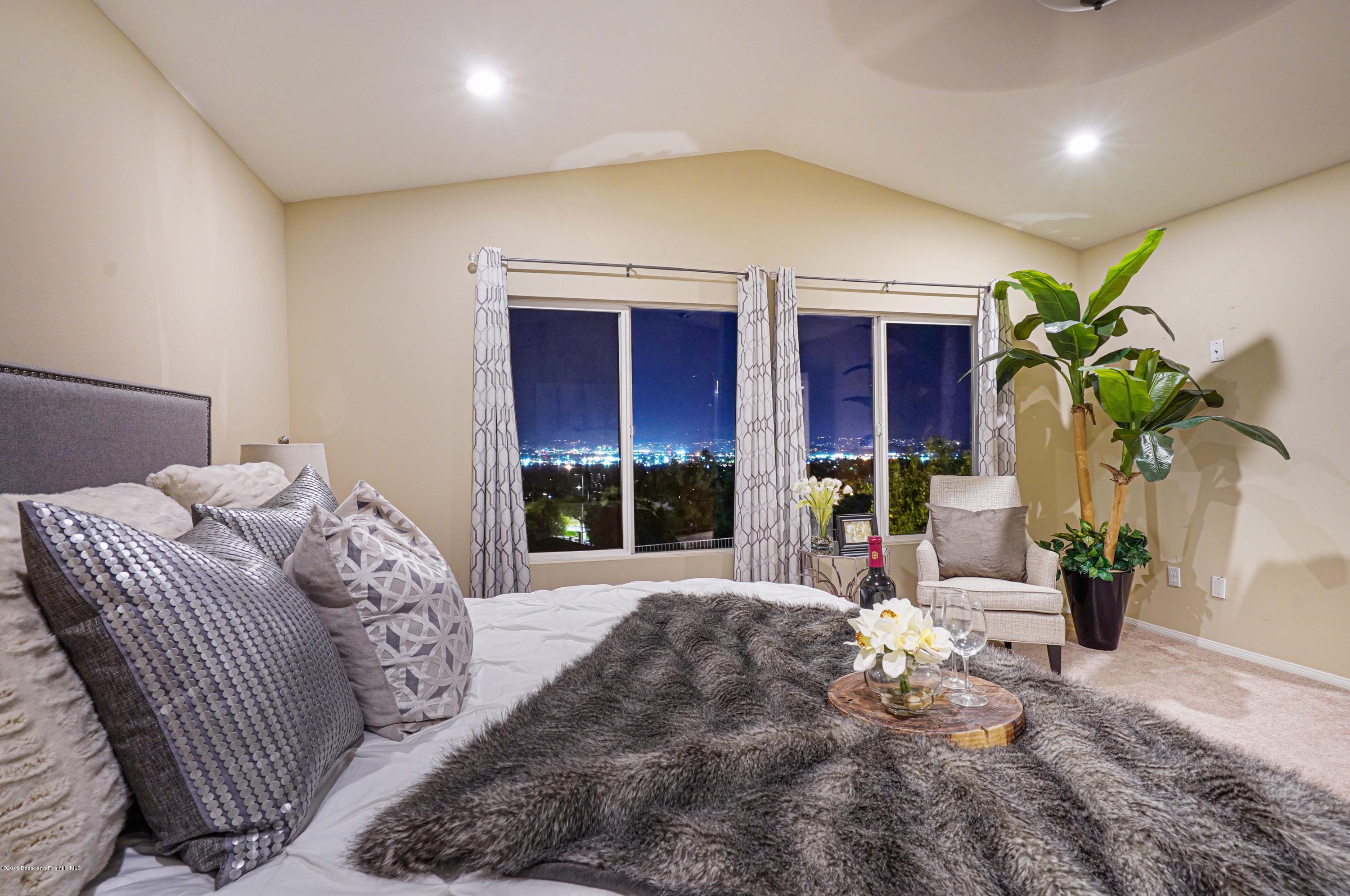 20548 Bergamo Way Porter Ranch, CA 91326 - Photo 36 of 58 a bed sitting in a bedroom next to a window and a potted plant