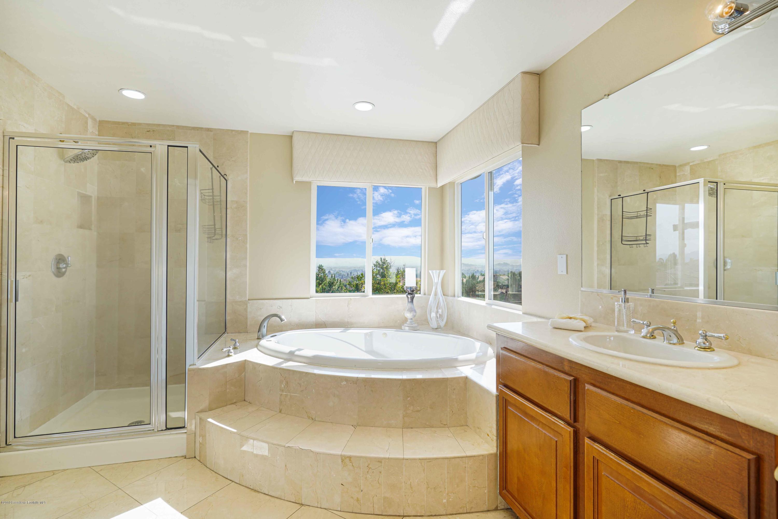 20548 Bergamo Way Porter Ranch, CA 91326 - Photo 41 of 58 a bathroom with a tub sink and shower