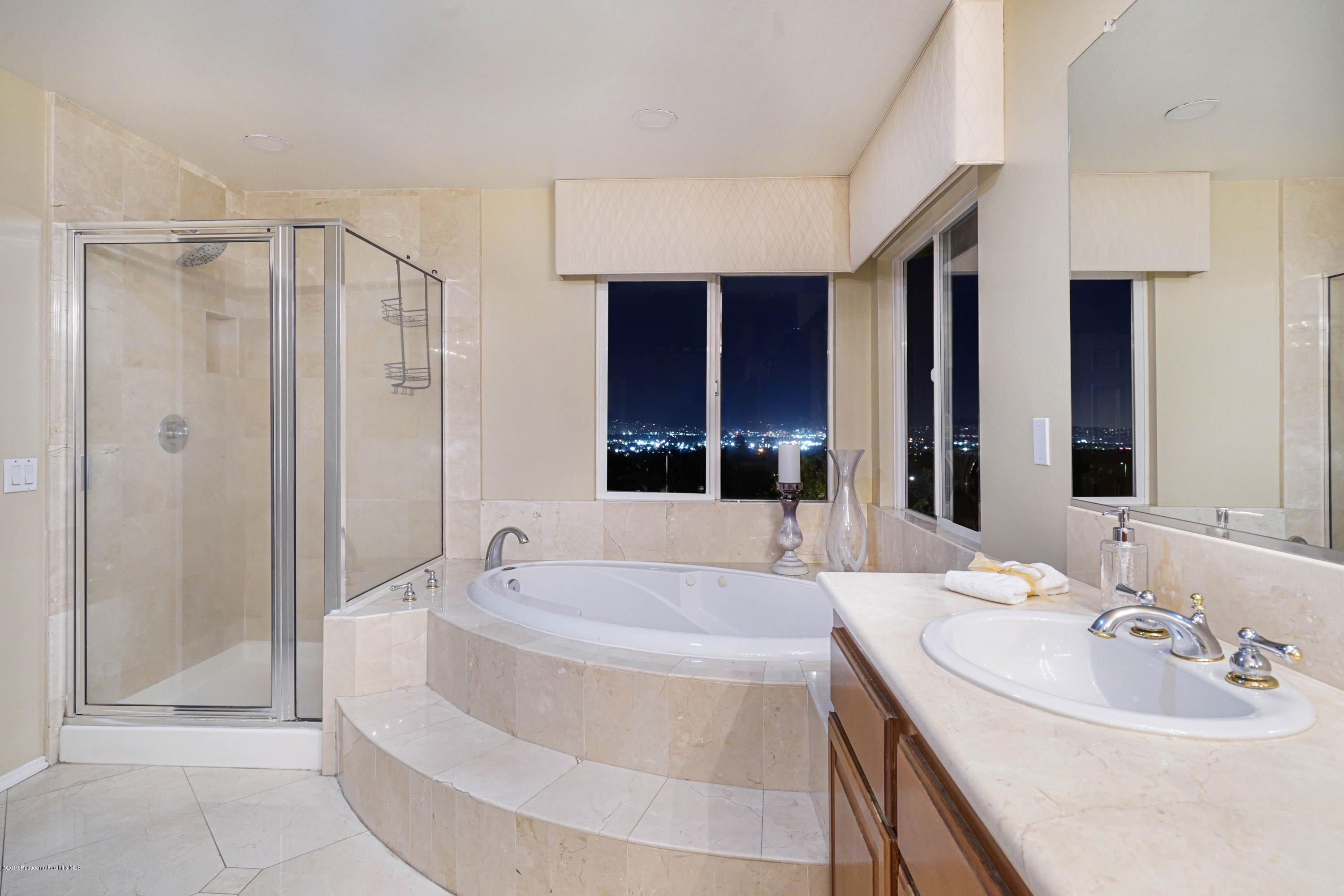 20548 Bergamo Way Porter Ranch, CA 91326 - Photo 43 of 58 a spacious bathroom with a tub sink and mirror
