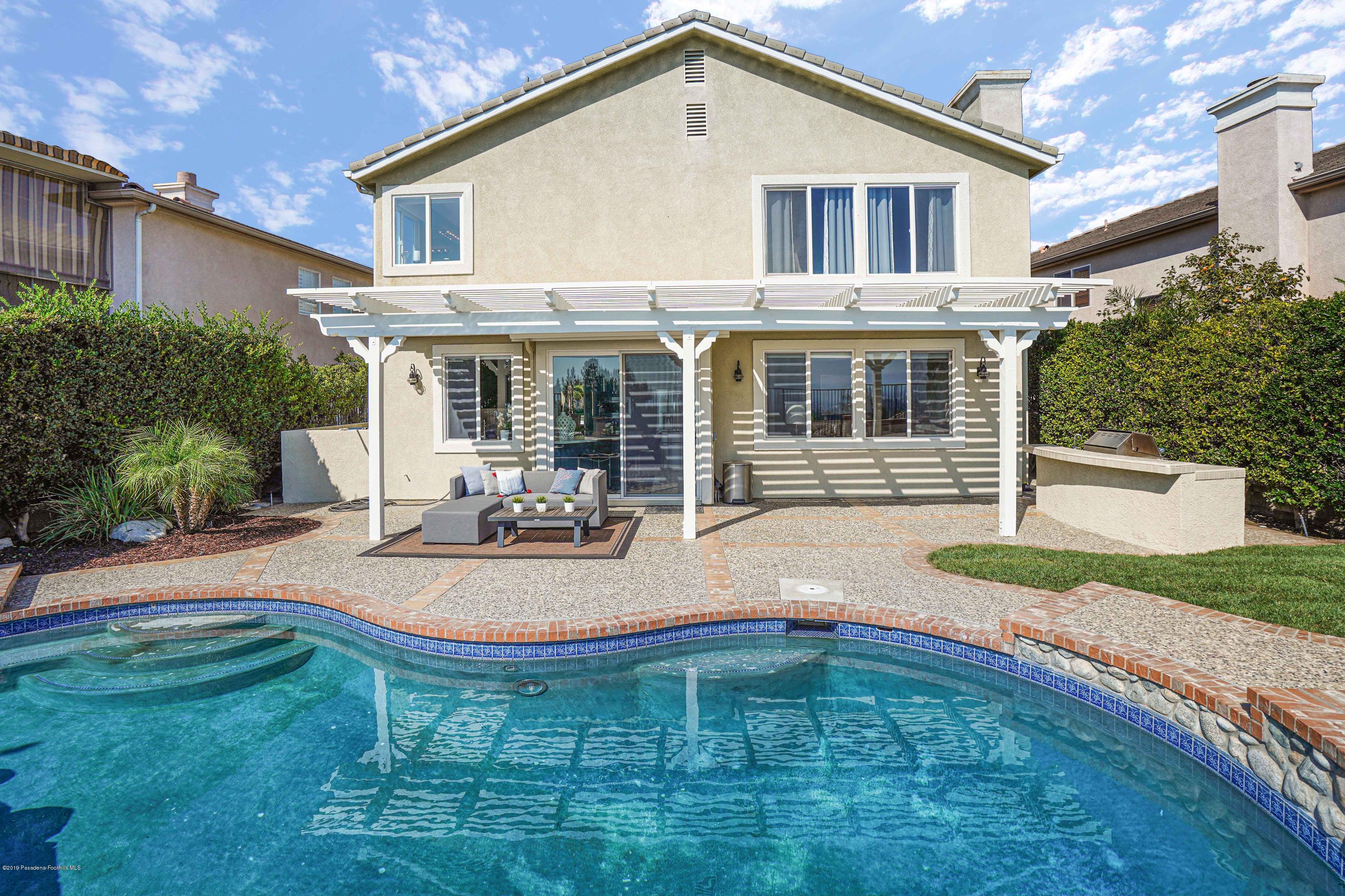 20548 Bergamo Way Porter Ranch, CA 91326 - Photo 44 of 58 a view of a house with backyard and sitting area