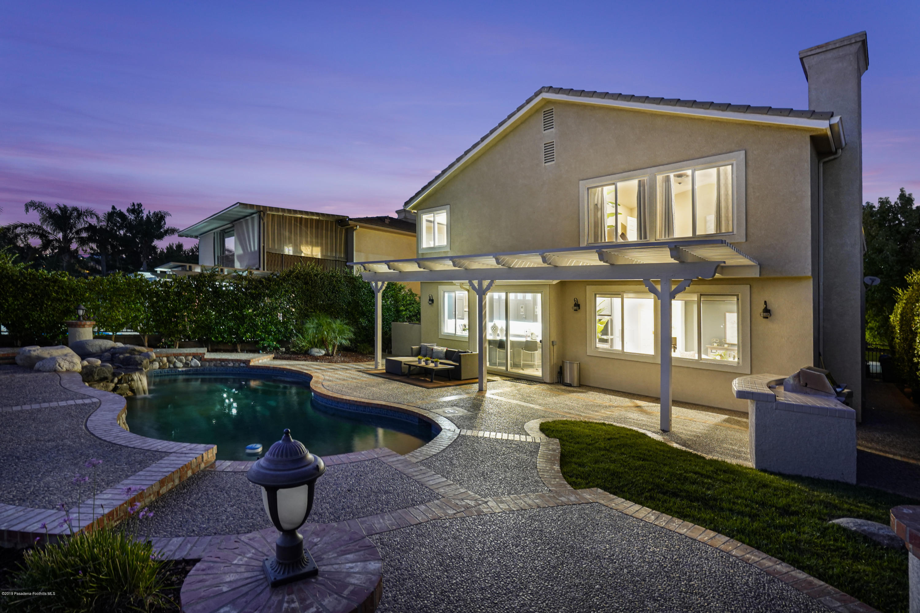 20548 Bergamo Way Porter Ranch, CA 91326 - Photo 46 of 58 a front view of a house with swimming pool and sitting area