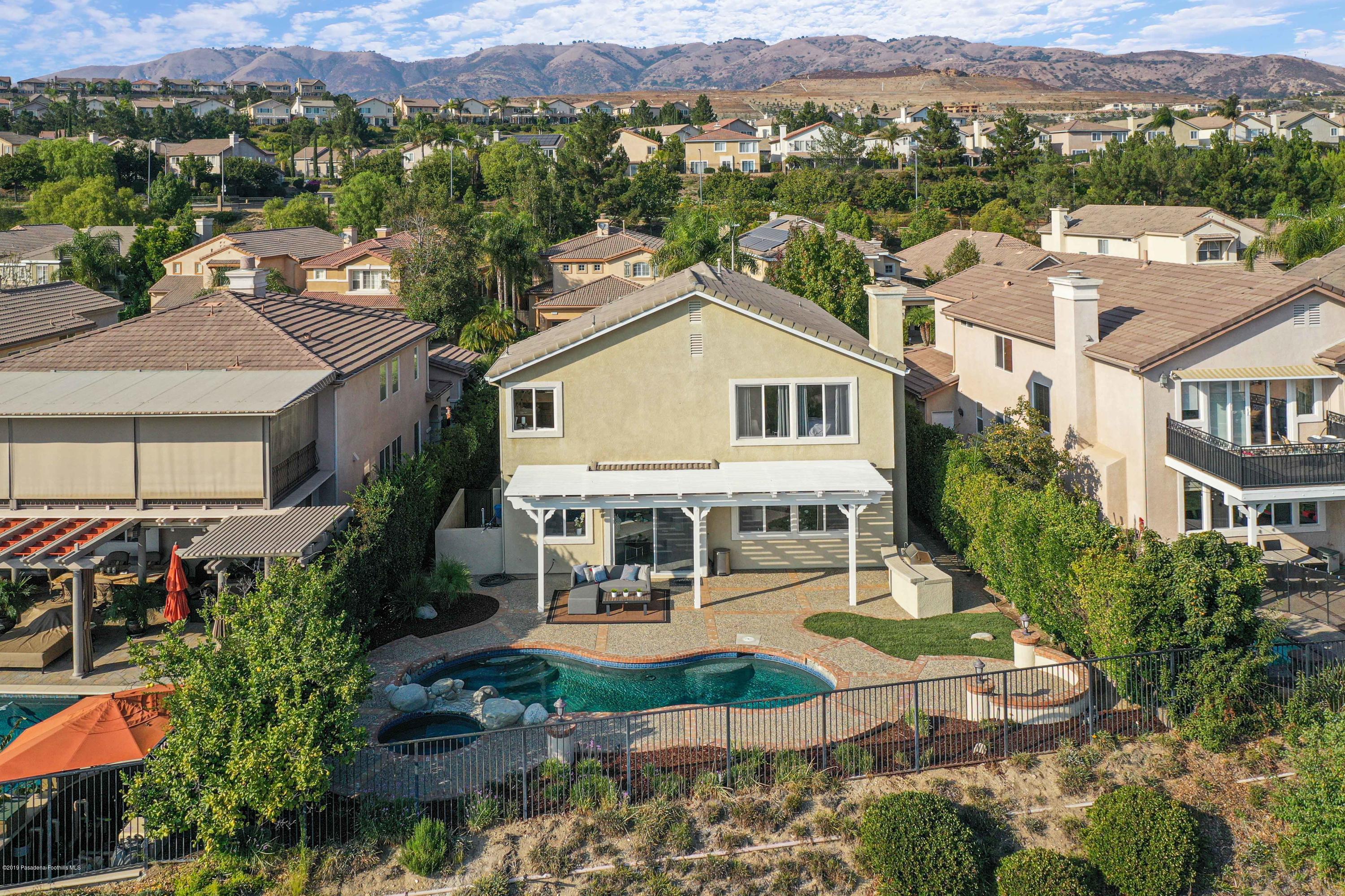 20548 Bergamo Way Porter Ranch, CA 91326 - Photo 55 of 58 an aerial view of a house with a yard lake and mountain view