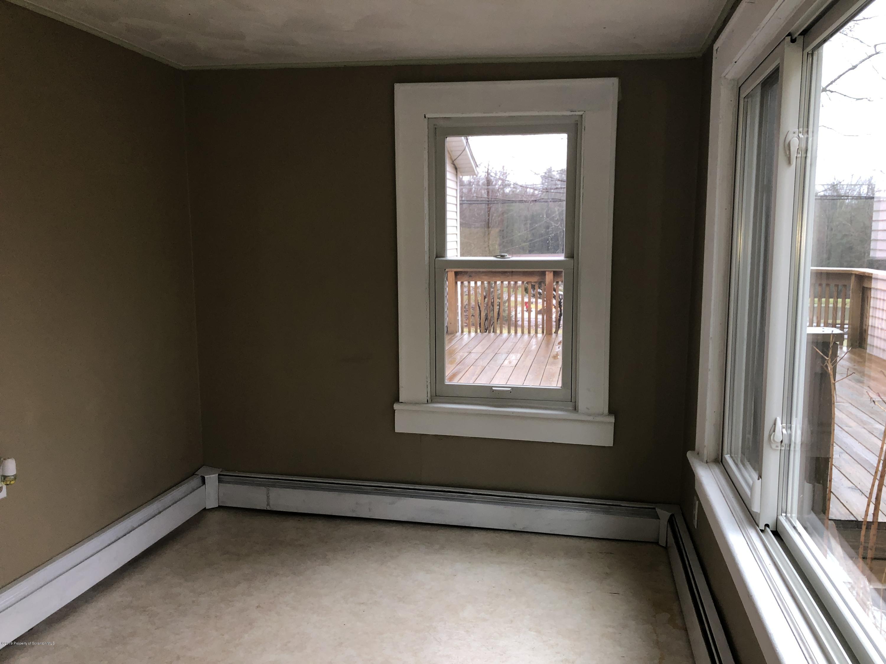 495 Cortez Road Lake Ariel, PA 18436 - Photo 16 of 39 a view of a small space with wooden floor and a window