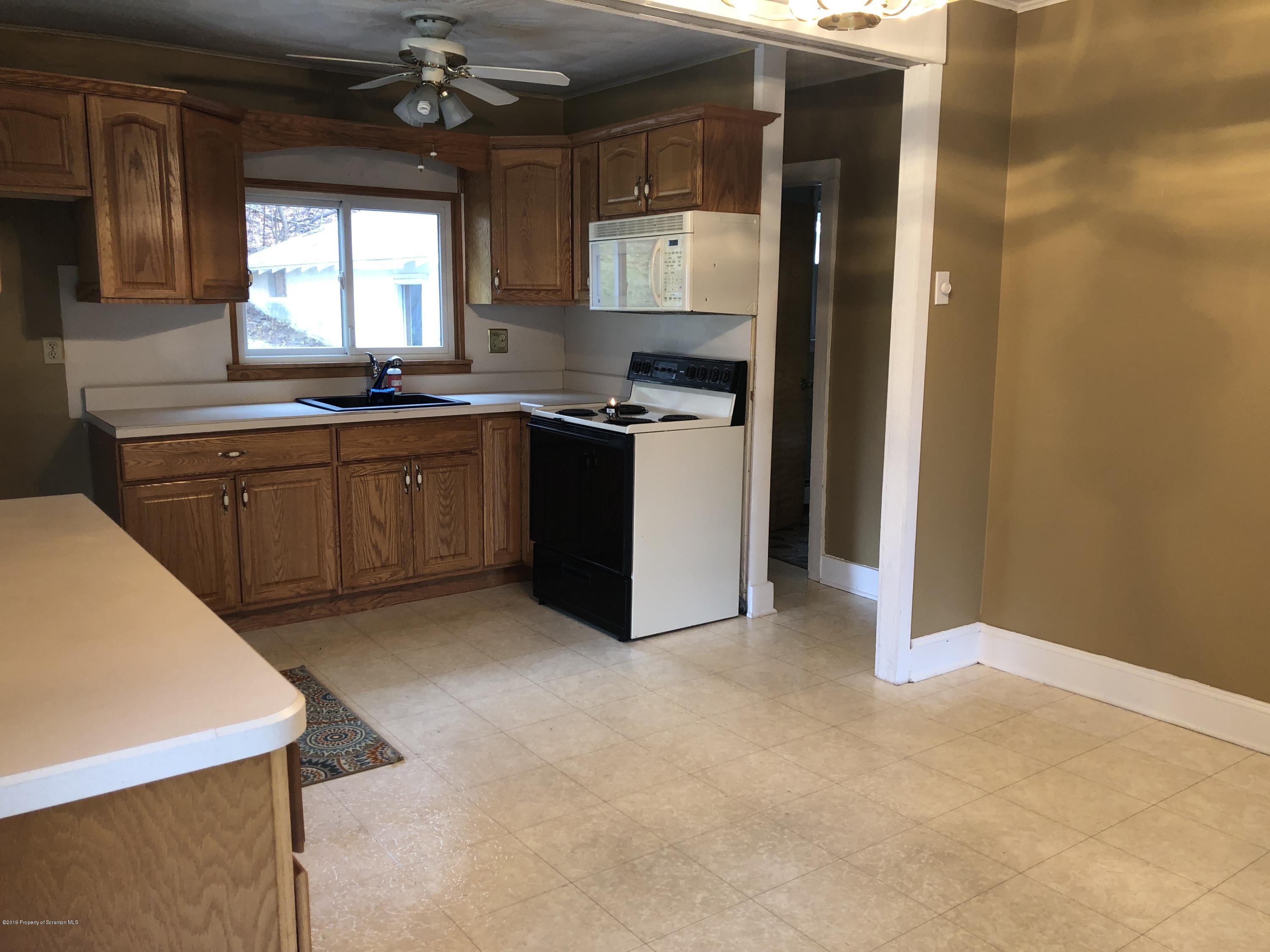 495 Cortez Road Lake Ariel, PA 18436 - Photo 5 of 39 a kitchen with granite countertop a sink cabinets and window