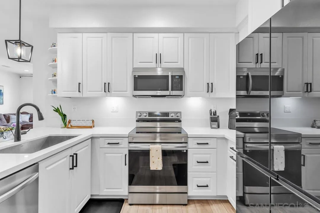 2811 Safflower Street Spring Valley, CA 91977 - Photo 7 of 28 a kitchen with cabinets stainless steel appliances and a sink