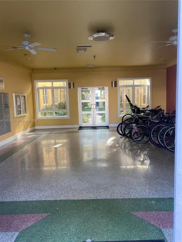 a view of a room with wooden floor and furniture