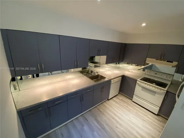 a kitchen with a sink and cabinets
