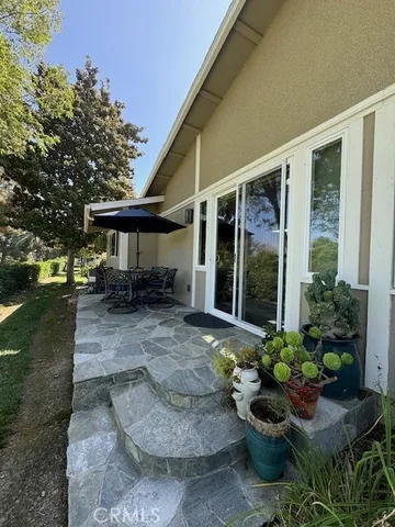 a view of a house with sitting area and garden