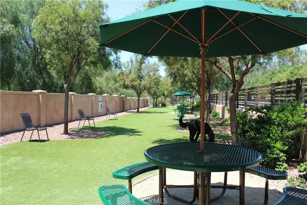 a backyard of a house with lots of green space and a fountain